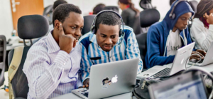 Two men collaborating on laptop in office