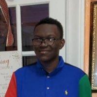 Person wearing blue polo shirt and glasses